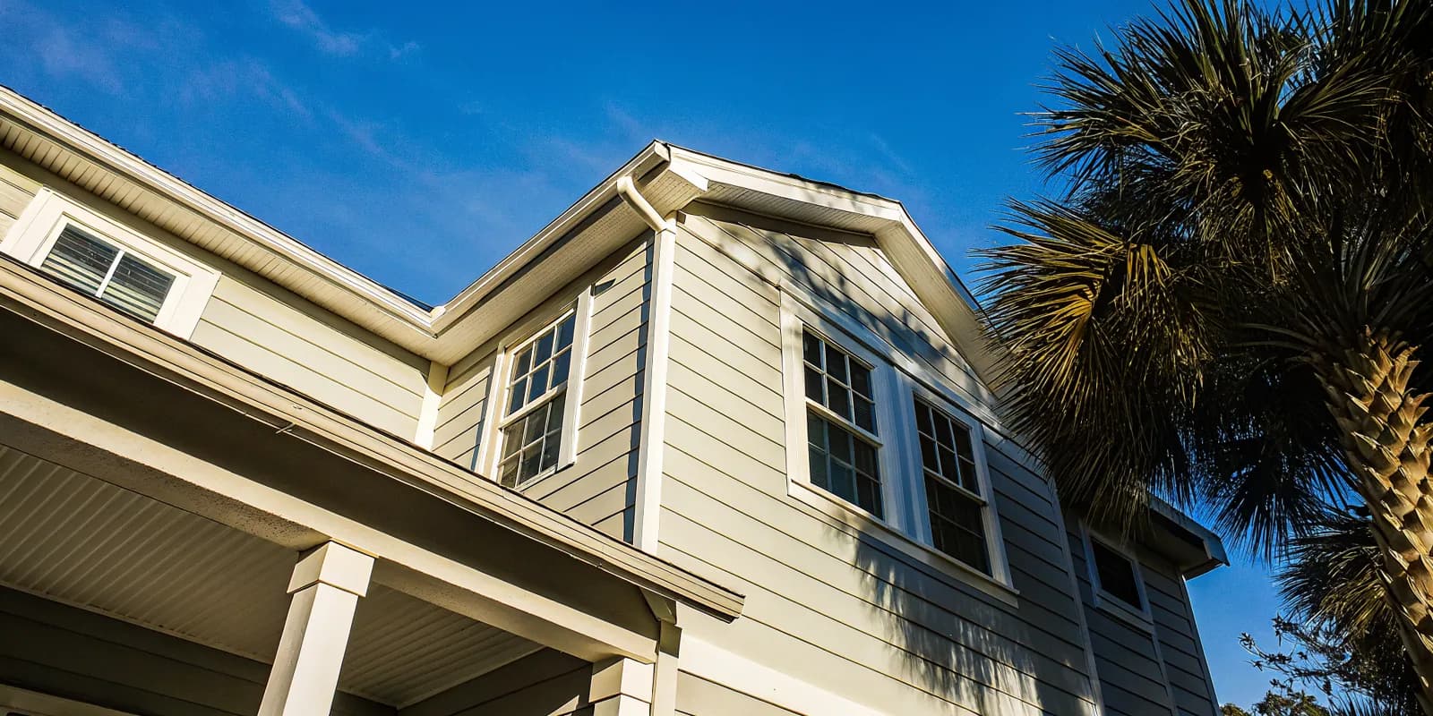Koehler installer fitting James Hardie fiber cement siding on a Florida home